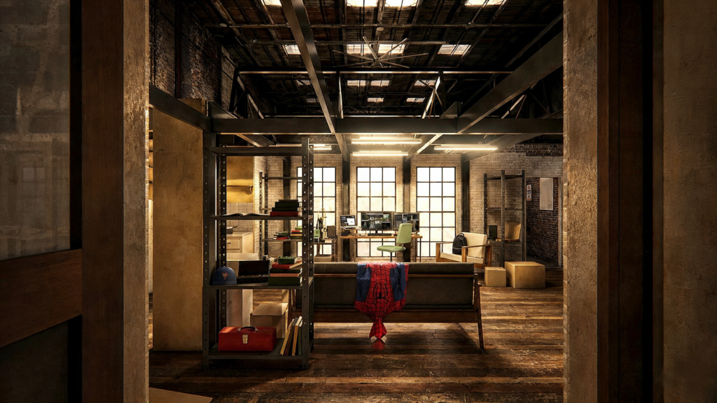 Loft industrial amplo e pouco mobiliado, com mesa de monitores ao fundo e o traje do Homem-Aranha jogado sobre o sofá